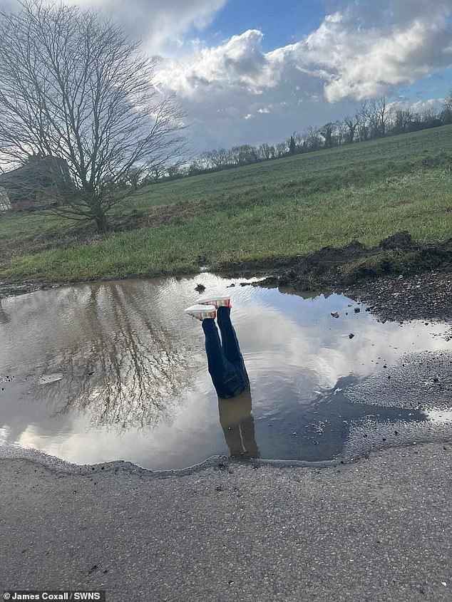 Angry father fed up with a three-foot-wide pothole in his village gets the last laugh with a cheeky act of revenge