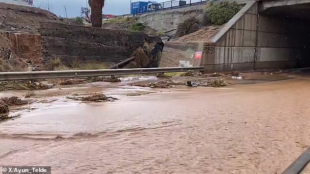 Streets become raging rivers on Spanish holiday island as massive floods wash cars out to sea and tourists are told to stay indoors