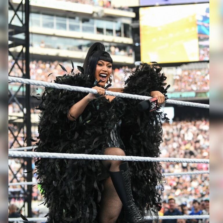 Cardi B Stuns in Custom Black Feather Corset, Dramatic Cape, and Le Silla Boots for WWE Performance of “Hello”