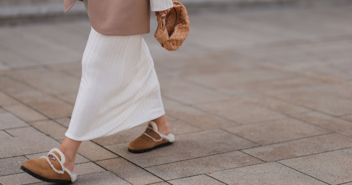 COLOGNE, GERMANY - AUGUST 22: Julia Zwingenberg wearing Christian Dior beige cat eye shades, beige oversized Acne Studios blazer, creme white long by Aylin Koenig dress, Bottega Veneta beige leather mini Jodie bag and Prada beige fur slip shoes on August 22, 2022 in Cologne, Germany. (Photo by Jeremy Moeller/Getty Images)