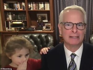 Finance expert’s ultra-serious TV interview is interrupted by adorable young granddaughter coming to tap his shoulder