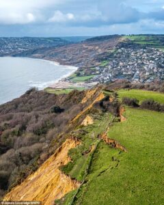Huge landslide closes part of South West Coastal Path: Thousands of tonnes of rock slump onto Dorset beach weeks after 300ft long crack appeared in cliff top