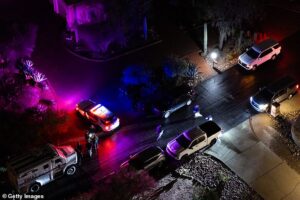 Nancy Guthrie investigators ‘detain four’, as neighbor claims they saw person shoot themselves in head and Range Rover is covered with sheets while cops investigate its trunk