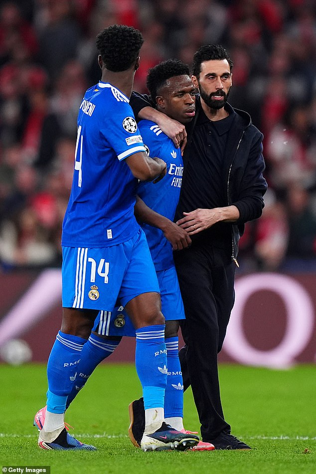 Furious Vinicius Jr accuses opponent of racially abusing him: Clash with Benfica stopped for 10 MINUTES as Real Madrid star storms off, coach is red-carded and Jose Mourinho pleads for calm in chaotic scenes