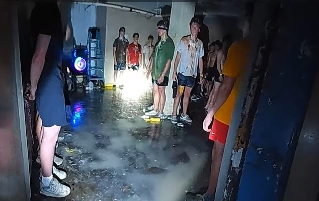 Moment police uncover 56 shirtless, blindfolded young men with food splattered on them in dark frat house basement
