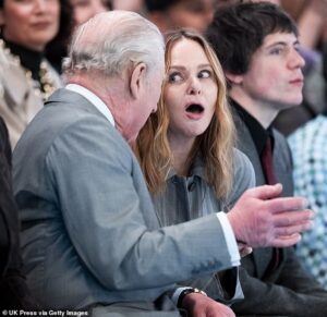 Keeping calm and carrying on! King Charles shares a laugh with Stella McCartney as he sits on front row of catwalk at London Fashion Week on day Andrew is arrested