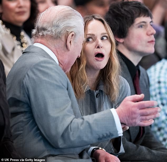 Keeping calm and carrying on! King Charles shares a laugh with Stella McCartney as he sits on front row of catwalk at London Fashion Week on day Andrew is arrested