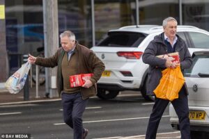 Andrew’s security team stock up on lager and noodles after driving him home from police station following arrest