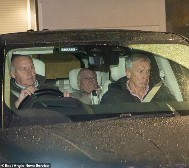 Now you see him, now you don’t: Cringeworthy new photos show Andrew trying to hide from photographer as he’s driven away from police station after questioning