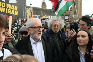 Jeremy Corbyn accuses Donald Trump of launching ‘clearly illegal attack to bring about regime change’ after joining hundreds of pro-Iran protesters in London carrying banners of the Ayatollah