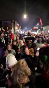 London street brought to a standstill as jubilant people blare music, hand out roses, and wave Iranian flags to celebrate the death of Ayatollah Ali Khamenei