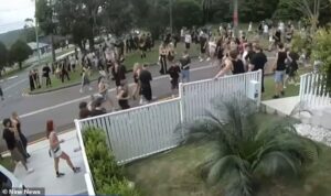 Chaos as 500 teenagers gatecrash party as riot squad and police helicopter are called in – while shocking footage shows boy being crash tackled to the ground by cops