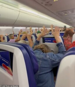 Moment terrified passengers hold their hands up as armed officers deplane travelers after alarm tone triggers threat alert