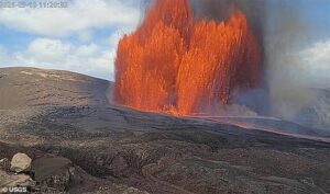 Hawaii’s mountain of fire roars to life, blasting giant rocks into the sky as homes brace for falling ash