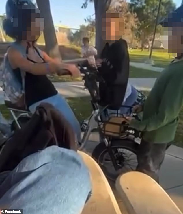 Distressing video shows black girl, 11, surrounded by group of older bullies who taunt her with racial slurs and hit her