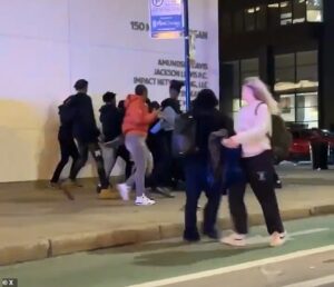 Nightmarish moment HUNDREDS of lawless teens overrun downtown Chicago on a quiet weeknight, amid reports of stores being looted and innocent pedestrians being maced