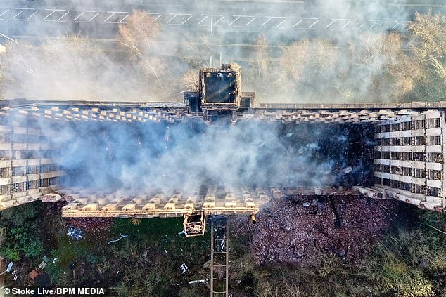 Teenager is arrested for arson after fire rips through historic Grade II-listed building as aerial pictures show roof and six floors destroyed