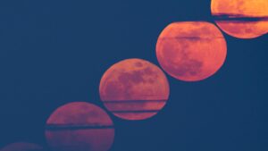 The March full moon glows red through Saharan dust in eerie composite view
