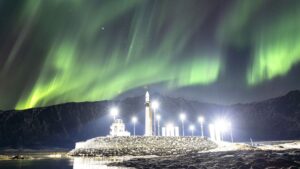 Rocket shines under the northern lights photo of the day for March 25, 2026