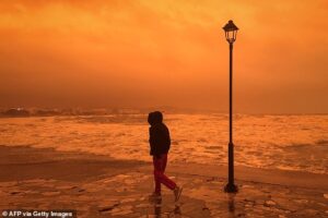 Greek island is cloaked by Saharan dust storm and hit by tornados with Easter holiday flights diverted and sky turning eerie red and orange