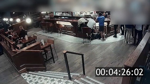 Moment two brazen thieves calmly go through pubgoers’ bags as they stand chatting nearby