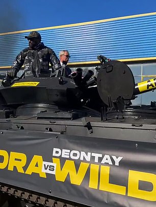 Derek Chisora arrives at Deontay Wilder press conference in a TANK alongside Reform leader and friend Nigel Farage