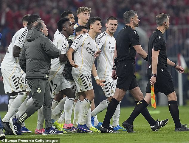 Real Madrid lose the plot after Bayern Munich defeat: Furious stars confront referee over controversial decision as player is sent off AFTER full-time before angry tunnel row in chaotic scenes