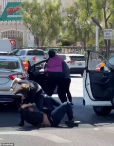 Brutal moment man viciously punches woman in middle of busy Las Vegas Boulevard after car crash… near hotel where WWE stars are preparing for WrestleMania