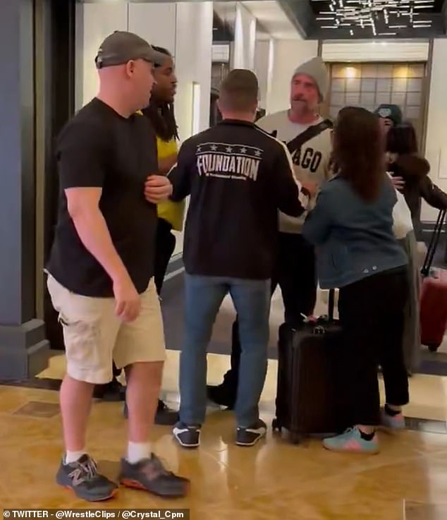 WWE legend caught in furious confrontation with fan after spotting him filming his wife in hotel lobby