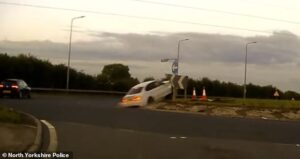 Moment drug-driver leads police on 140mph chase before BMW crashes into roundabout and somersaults through the air