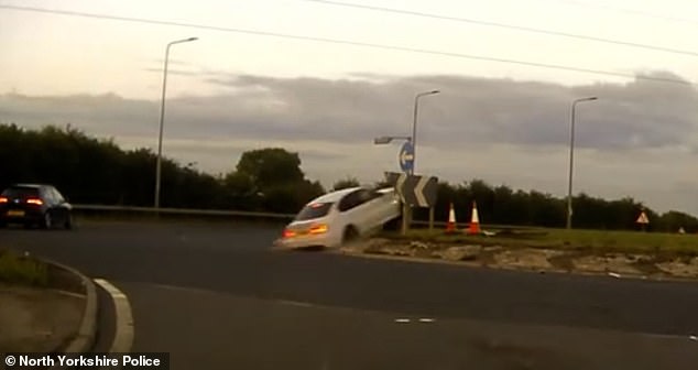 Moment drug-driver leads police on 140mph chase before BMW crashes into roundabout and somersaults through the air