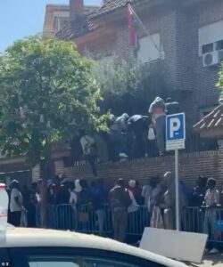 Clambering to get into Europe after Spain opened its doors: Migrants climb over embassy wall to skip huge queues and grab paperwork after socialist PM offered 500,000 legal status to stay