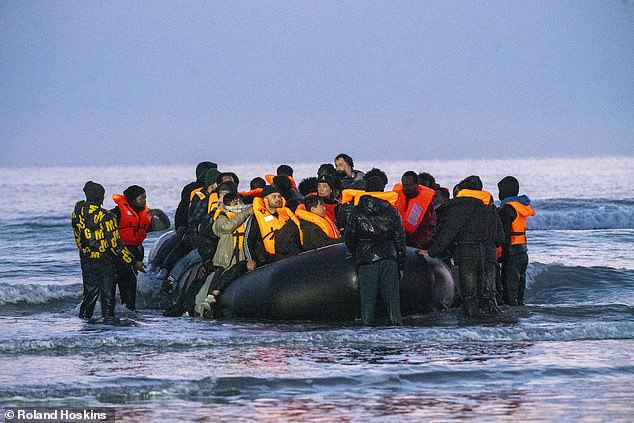 Migrants pile into death-trap dinghies in bid to traverse the Channel as French police watch on and do nothing AGAIN – with number of small boat crossings set to hit 200,000