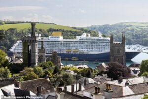 ‘What a horrible sight despoiling both land and sea!’: Cornish residents are in uproar as 58,000-ton cruise ship that can carry 1,500 docks in their picturesque town (population 2,240)