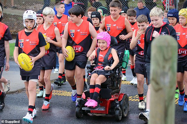 See the heartwarming moment a wheelchair-bound boy kicks his first footy goal – and even his opponents helped make it happen
