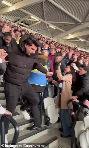 Shocking moment Arsenal fan is thrown down stadium steps after angering West Ham supporters by sitting in home end