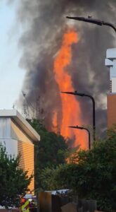 Two London railway lines are out of action after fire breaks out – destroying cars and a caravan