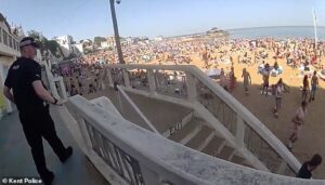 Moment police rush onto packed beach to arrest ‘drunk’ youngsters and pour out booze during bank holiday heatwave madness