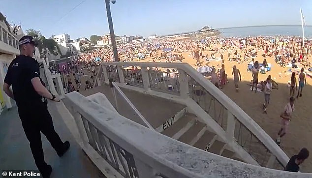 Moment police rush onto packed beach to arrest ‘drunk’ youngsters and pour out booze during bank holiday heatwave madness