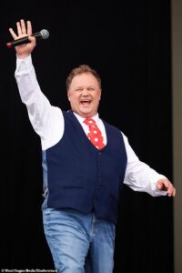Kids’ TV icon Mr Tumble, 55, is ‘madly in love’ with co-star 21-years his junior as CBeebies stars enjoy a quiet life on his £2.5million farm