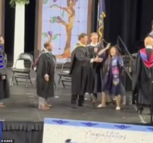 High school graduation thrown into chaos as teacher grapples with celebrating students and forces them into awkward handshakes
