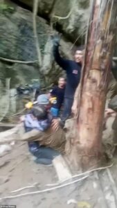 Rescuers free four men who had been trapped in flooded Laos cave for more than a week as two are still missing