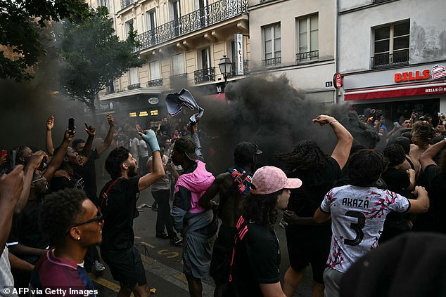 PSG fans clash with riot police on streets of Paris as night of chaos looms after Champions League final victory over Arsenal