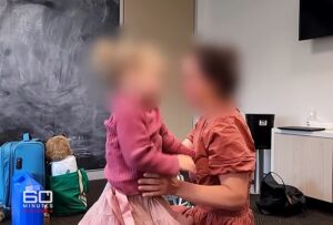 Emotional moment reporter fights back tears as Aussie mother plays clip of her toddler being returned to her allegedly abusive father under controversial international law