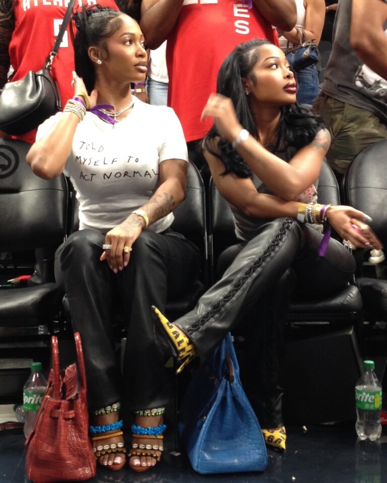 Dess Dior in Vintage Giuseppe Zanotti Shell Heels and Jayda Cheaves in Balenciaga Caution Tape Pumps at an Atlanta Dream WNBA Game