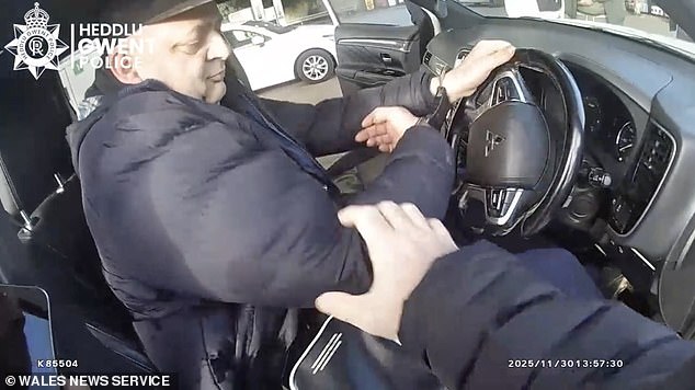 Moment handcuffed criminal speeds away from police with his car doors open after being arrested