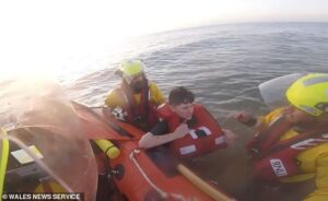 Moment terrified beachgoer is saved from drowning after getting trapped in sinking sands and rising tides