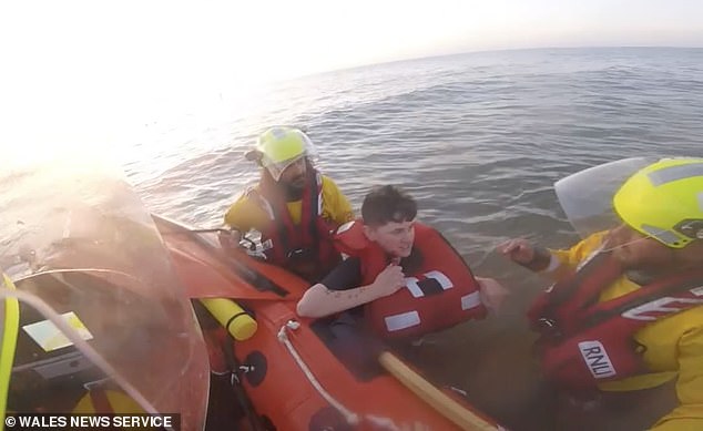 Moment terrified beachgoer is saved from drowning after getting trapped in sinking sands and rising tides
