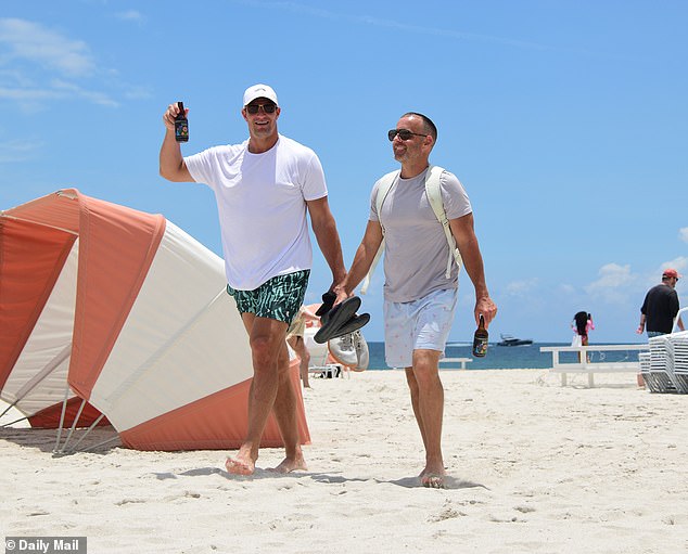 NFL legend Rob Gronkowski guzzles ‘feel-good’ botanical drink on Miami Beach ahead of girlfriend Camille Kostek’s stunning appearance at Sports Illustrated Swimsuit runway show