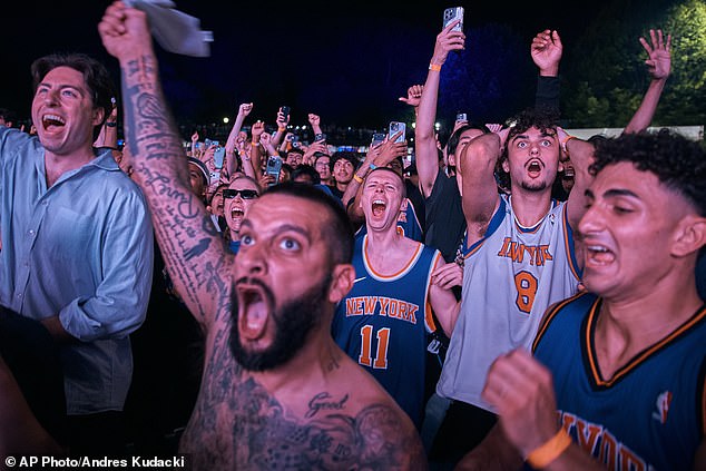 New York City descends into total CHAOS as fans jump on cop cars and buses while riot police rush to keep control after Knicks win first NBA Championship in 53 years